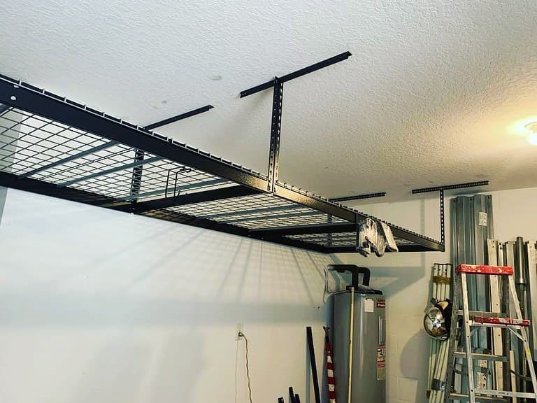 Similar overhead shelving install garage black steel supports ceiling texture silver tank ladder cropped frame.